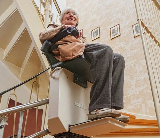 Person using a stairlift in a home setting